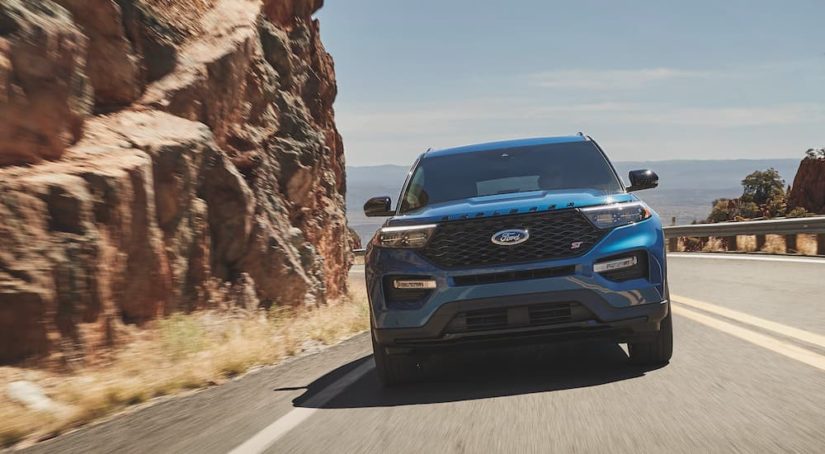 A blue 2021 Ford Explorer ST is shown from the front after leaving a dealer that has a used SUV for sale near me.