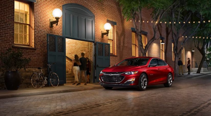 A red 2020 Chevy Malibu is shown from the front at an angle.