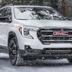 A white 2021 GMC Terrain is shown from the front at an angle.
