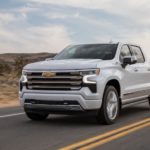 A white 2023 Chevy Silverado 1500 High Country is shown from the front at an angle.