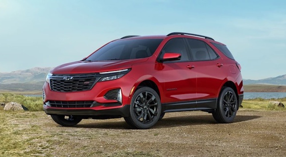 A red 2022 Chevy Equinox RS is shown from the side while parked.