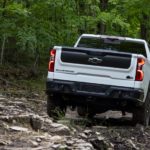 A white 2023 Chevy Silverado ZR2 Bison is shown from the rear at an angle.