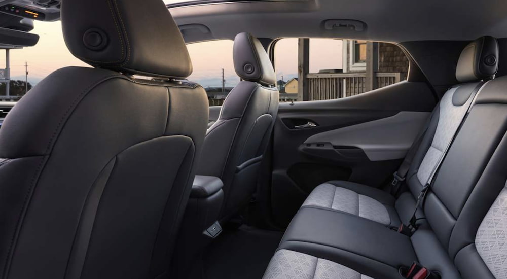 The grey and black interior of a 2023 Chevy Bolt EUV shows the back seats.