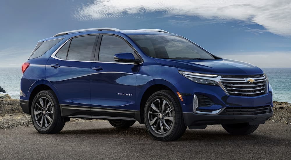 A blue 2023 Chevy Equinox is shown from the side.
