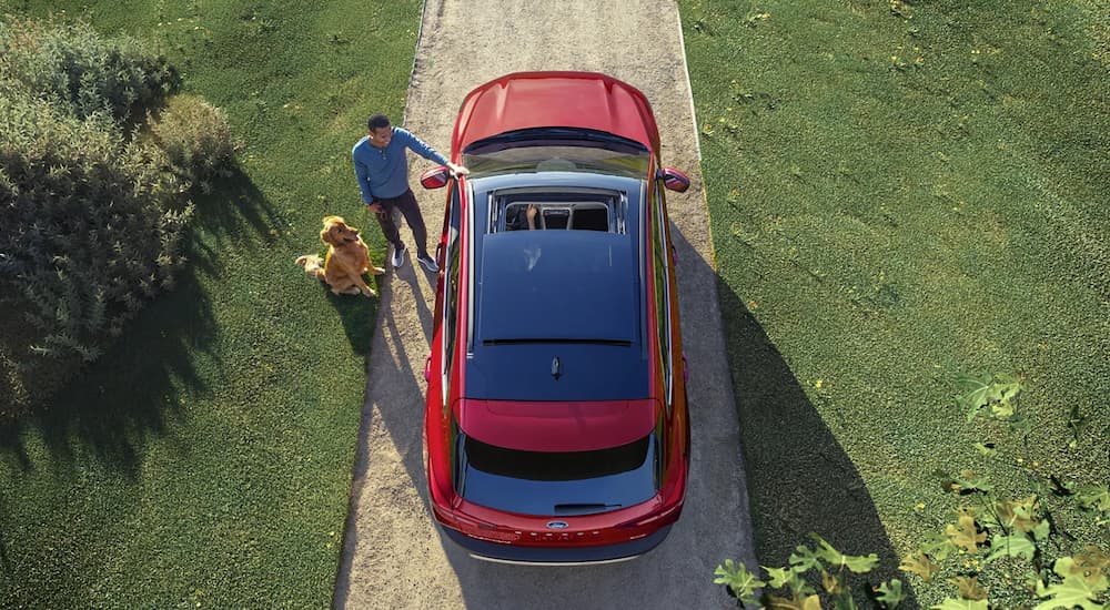 A red 2023 Ford Escape is shown from above while parked in a driveway.