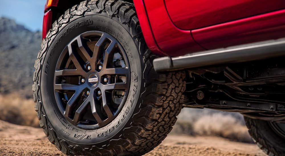 A close up shows a black rim on a red 2023 Ford Ranger.