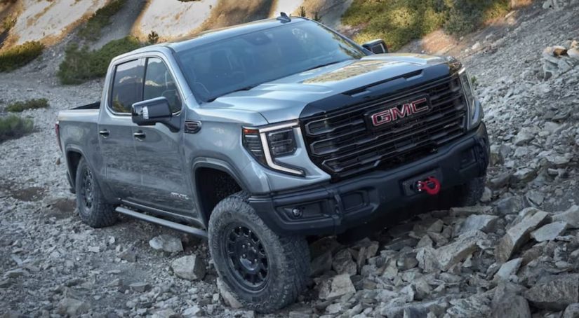 A grey 2023 GMC Sierra 1500 AT4X is shown off-roading.