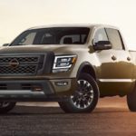 A brown 2023 Nissan Titan Pro-4x is shown parked in an open dirt area.