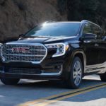 A black 2023 GMC Terrain Denali is shown from the front at an angle.