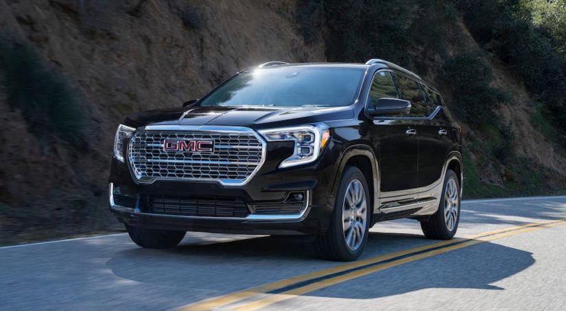 A black 2023 GMC Terrain Denali is shown from the front at an angle.