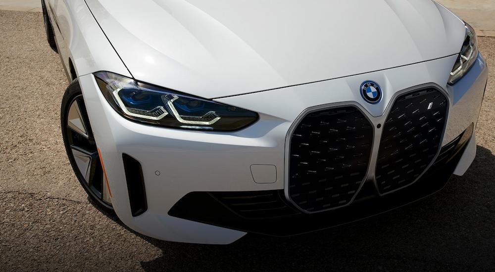 A close up of the front grille of a white 2023 BMW i4 M50 is shown.