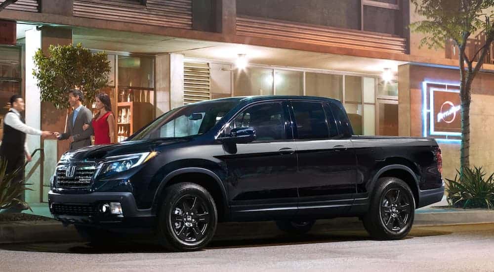 A black 2020 Honda Ridgeline Black Edition is shown in front of a restaurant.