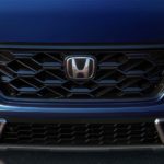 A close up shows the grille on a dark blue 2023 Honda CR-V Hybrid Sport Touring after leaving a Honda dealer.