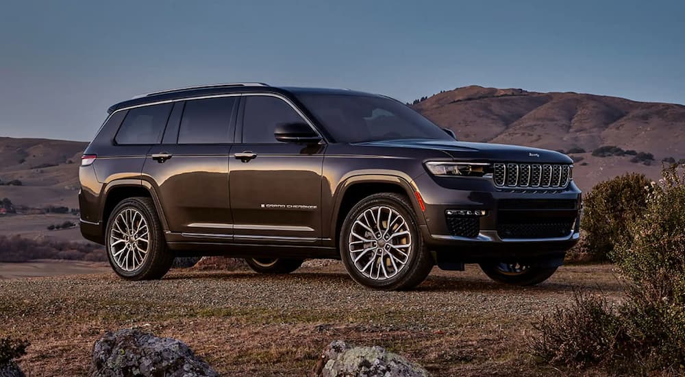 A black 2023 Jeep Grand Cherokee for sale is shown parked in a desert.
