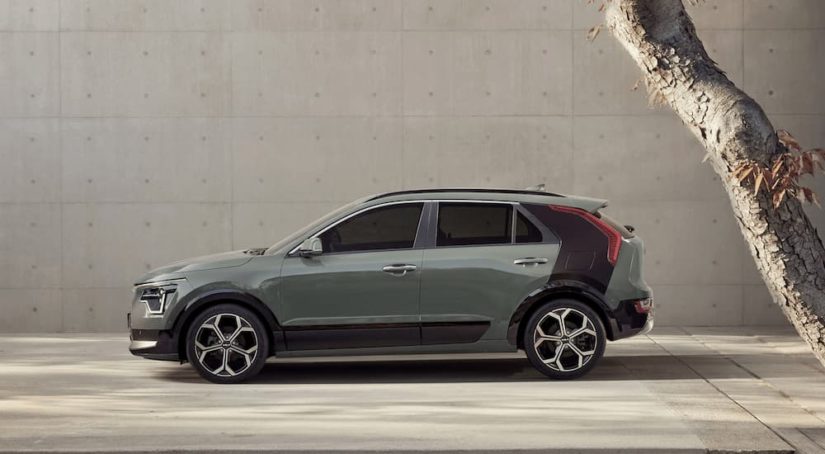 A green 2023 Kia Niro is shown from the side parked at a Kia Niro dealer.