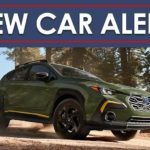 A green 2024 Subaru Crosstrek Sport is shown on a trail under a new car alert banner.