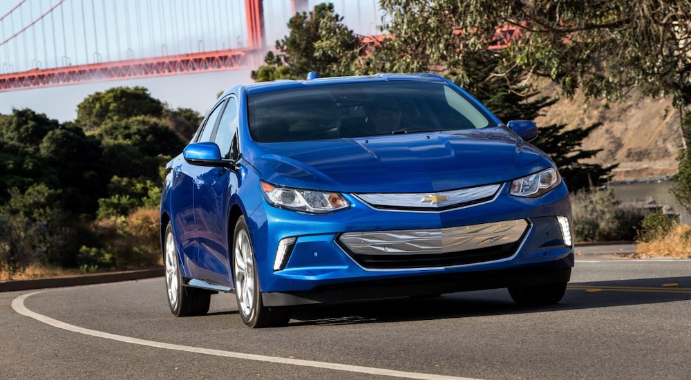 A blue 2018 Chevy Volt EV is shown from the front at an angle after leaving a used car dealer.