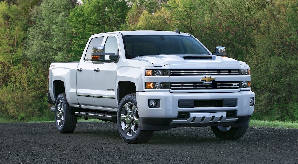 A white 2017 Chevy Silverado 2500HD is shown parked in an empty parking lot.