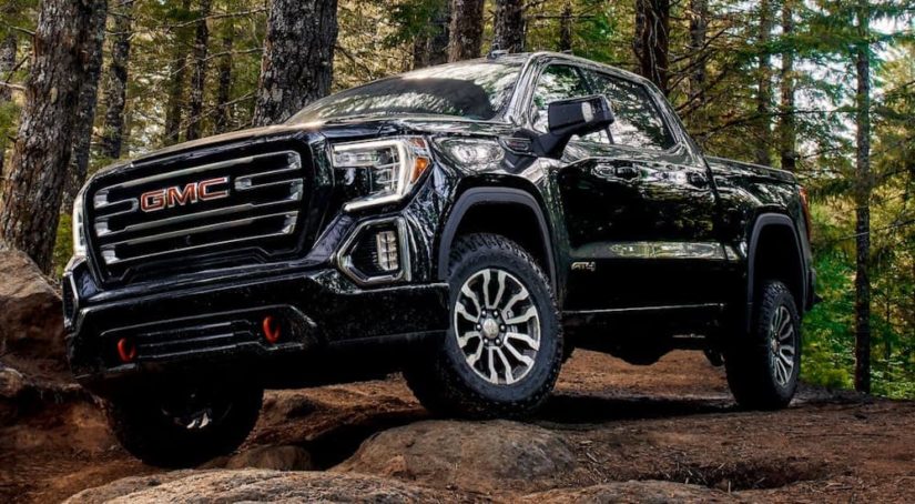 A black 2019 GMC Sierra 1500 AT4 is shown from the front at an angle while off-road.
