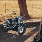 A black 2021 Harley-Davidson Fat Boy 114 is shown from the front while parked.