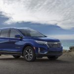A blue 2023 Chevy Equinox Premier is shown from the side during a 2023 Chevy Equinox vs 2023 Toyota RAV4.