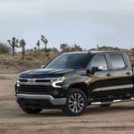 A black 2023 Chevy Silverado 1500 LT is shown from the front at an angle during a 2023 Chevy Silverado 1500 vs 2023 Ford F-150 comparison.