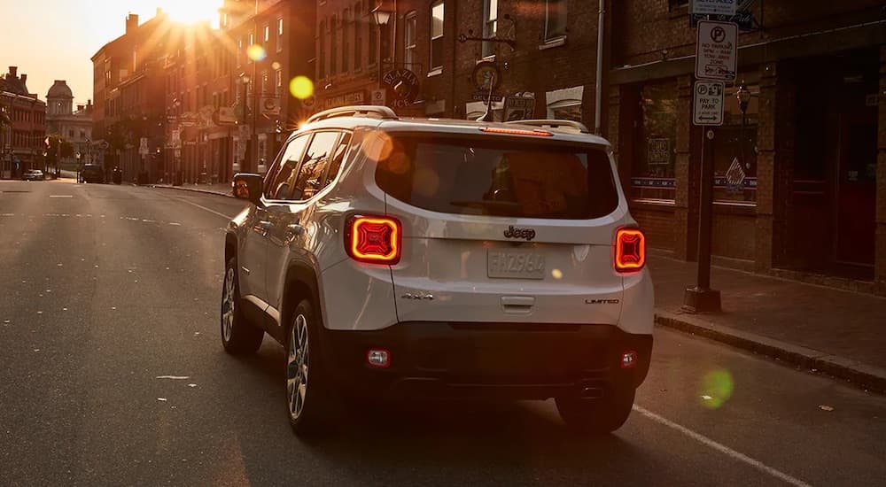 A white 2022 Jeep Renegade Limited is shown from th erear on a city street.