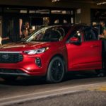 People are shown getting into a red 2023 Ford Escape ST-Line Elite.