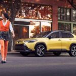 A yellow 2023 Toyota Corolla Cross Hybrid XSE is shown parked on the street.