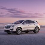 A white 2023 Cadillac XT5 is shown from the side.