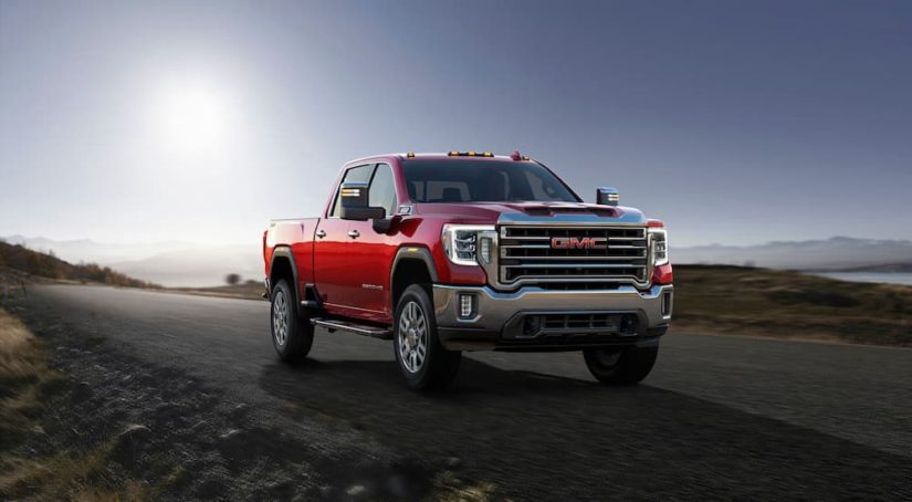 A red 2023 GMC Sierra 2500HD is shown from the front at an angle.