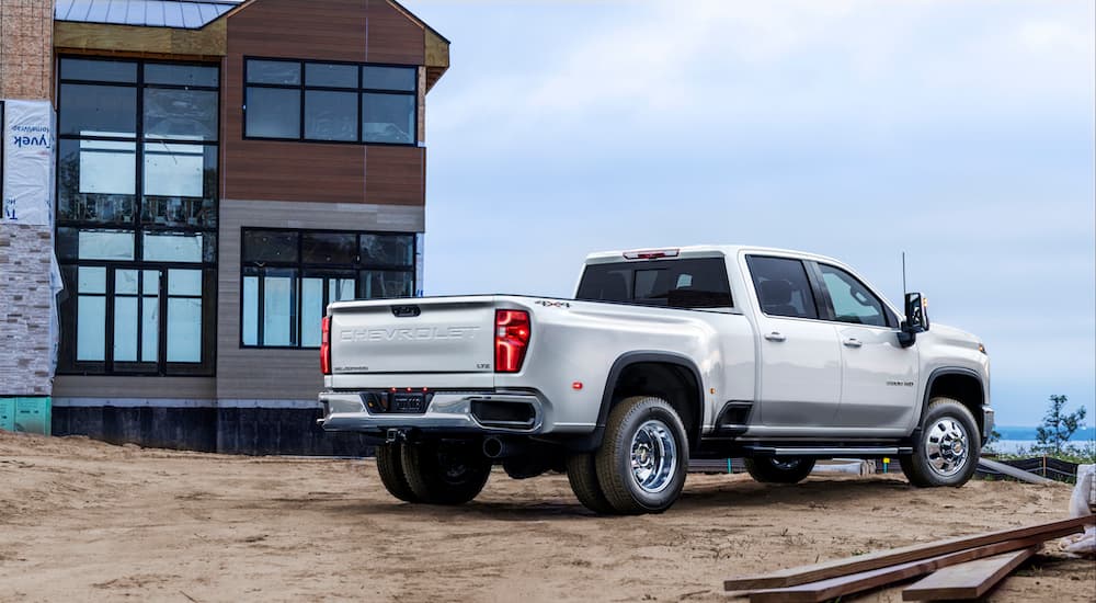 A white 2024 Chevy Silverado 3500HD LTZ is shown from the rear at an angle.
