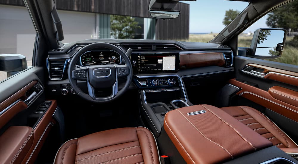 The brown interior of a 2024 GMC Sierra 2500 HD Denali is shown from the driver's seat.