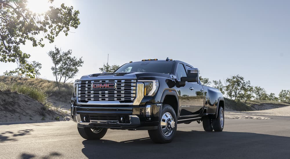 A black 2024 GMC Sierra 3500 HD is shown from the front at an angle.