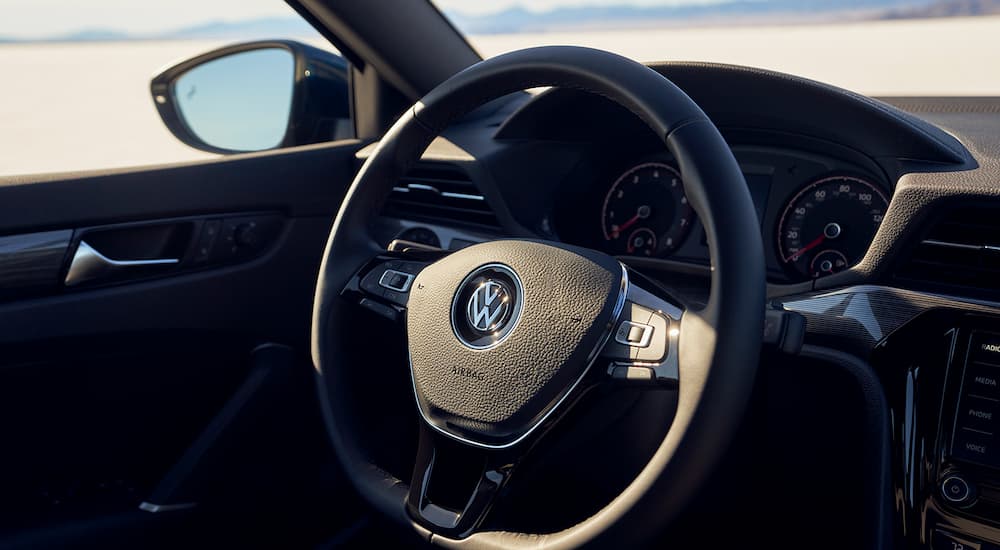 A closeup of the steering wheel in a 2022 Volkswagen Passat is shown.