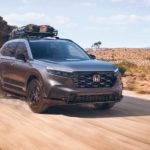 A grey 2023 Honda CR-V is shown from the front at an angle on a trail.