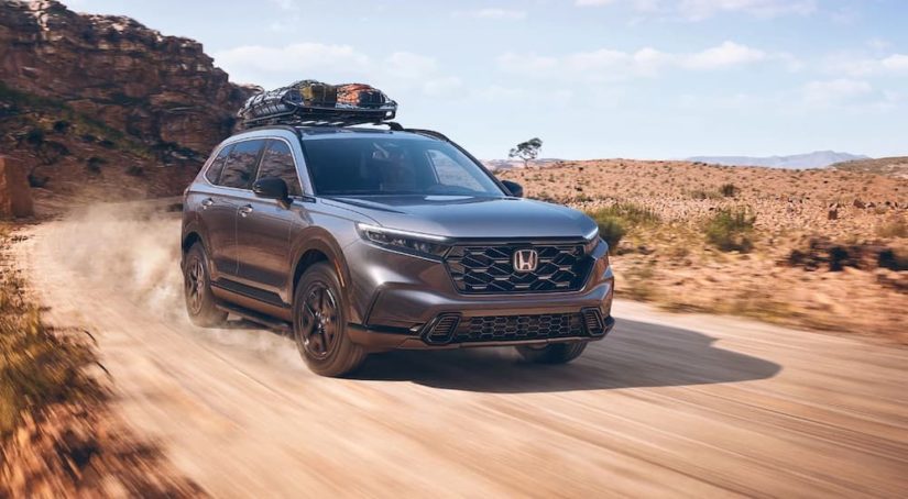A grey 2023 Honda CR-V is shown from the front at an angle on a trail.