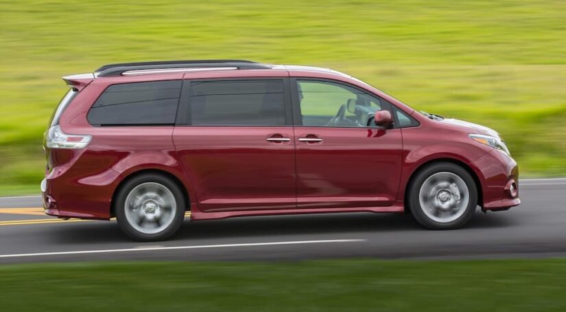 A red 2017 Toyota Sienna is shown from the side.