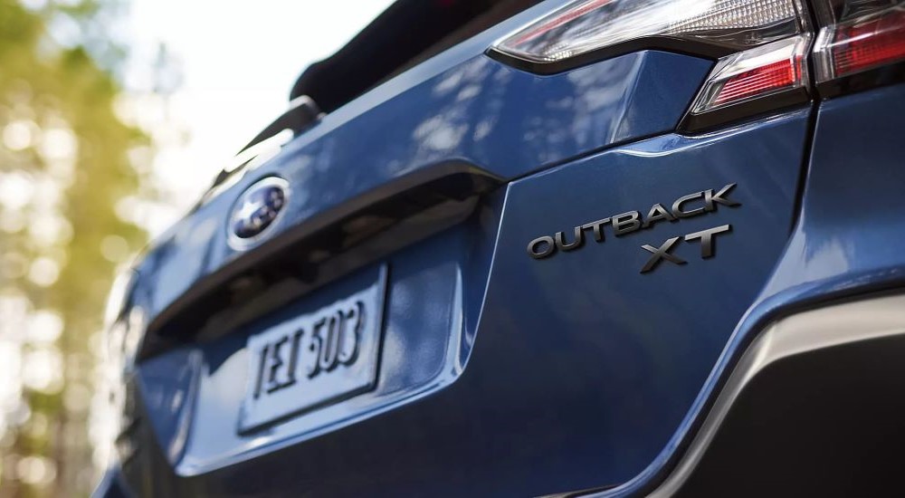 The rear of a dark blue 2023 Subaru Outback is shown.