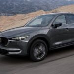 A grey 2020 Mazda CX-5 is shown from the front at an angle after leaving a Mazda dealer.