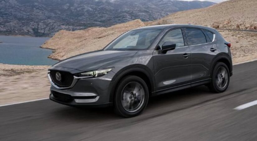 A grey 2020 Mazda CX-5 is shown from the front at an angle after leaving a Mazda dealer.