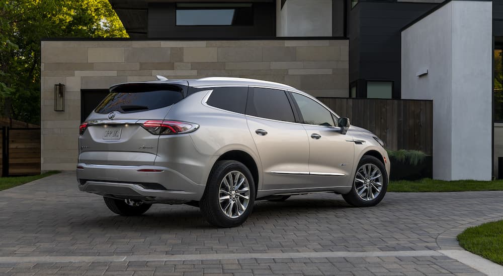 a silver 2022 Buick Enclave Avenir is shown from the rear at an angle after leaving a Buick dealer.