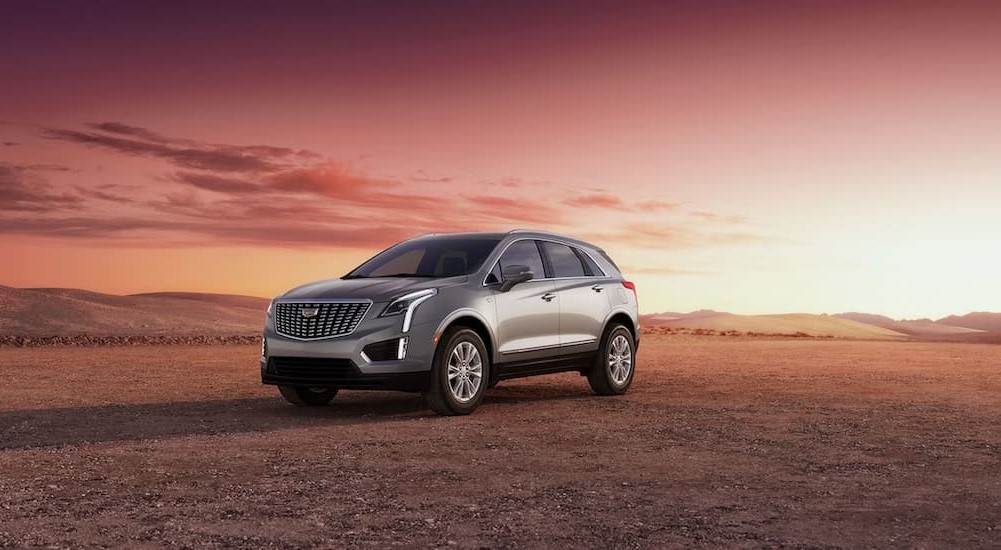 A 2023 Cadillac XT5 is shown parked off-road.