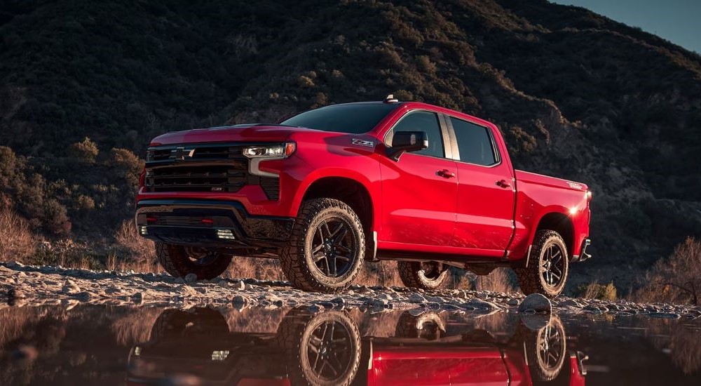 A red 2023 Chevy Silverado 1500 Z71 Trail Boss is shown off-roading.