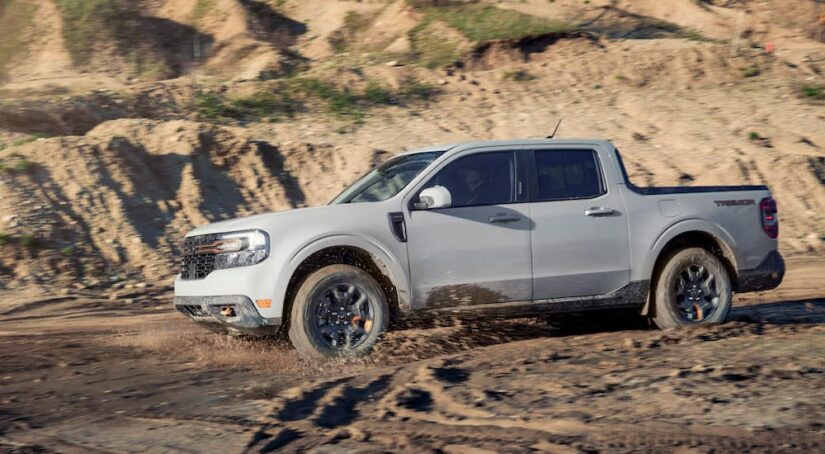 A grey 2023 Ford Maverick Tremor is shown from the side while off-road.