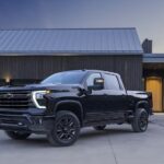 A black 2024 Chevy Silverado 2500 HD High Country is shown from the front at an angle.