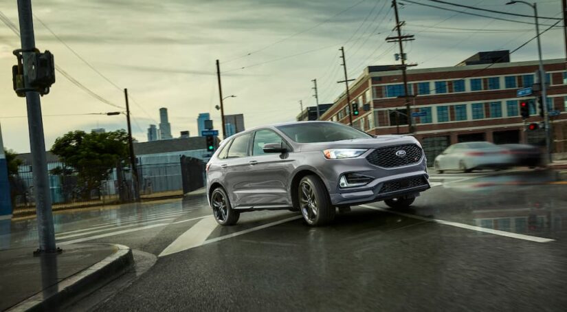A grey 2022 Ford Edge ST is shown from the front at an angle on a city street.