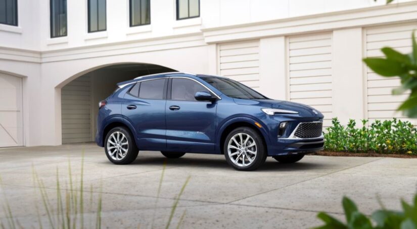 A blue 2024 Buick Encore GX Avenir is shown parked in a driveway after leaving a Buick dealer.