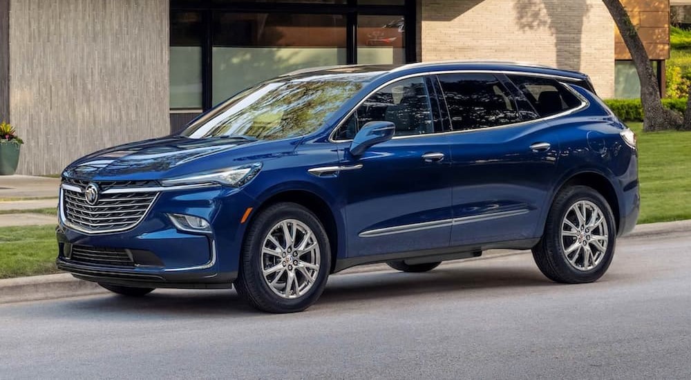 A blue 2023 Buick Enclave is shown parked on a street.