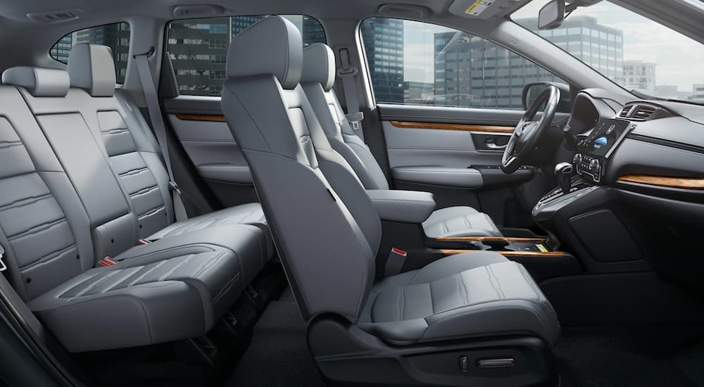 The white interior of a 2020 Honda CR-V is shown from the passenger side.